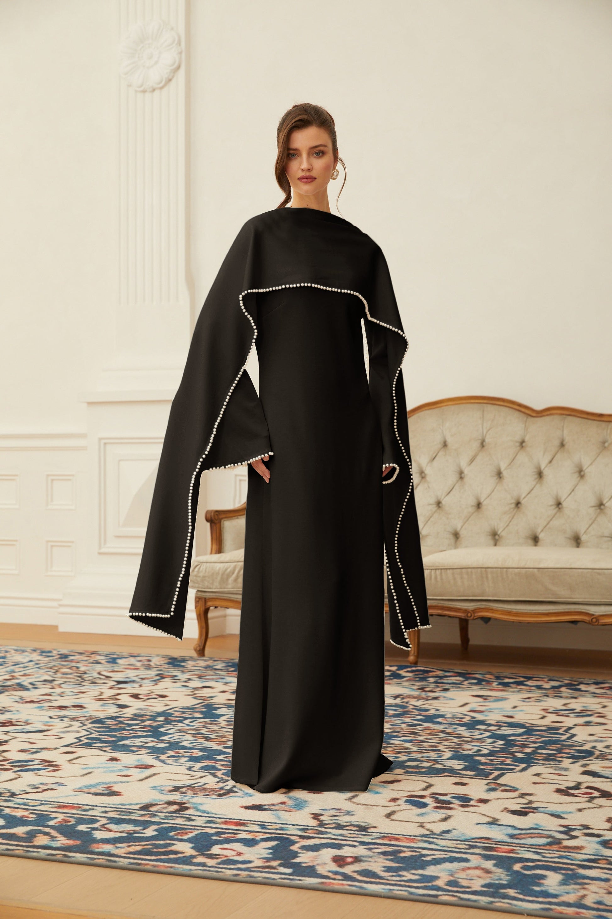 Montaracrest Piroska black maxi dress with pearl-trim shawl detail, flowing fabric, and elegant design for formal occasions.