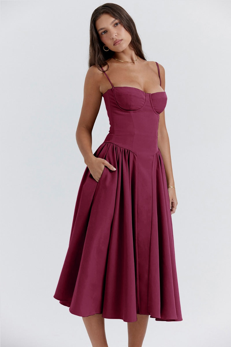 Montaracrest midi pleated dress with structured bodice and side pockets, showcasing elegant design and feminine style.