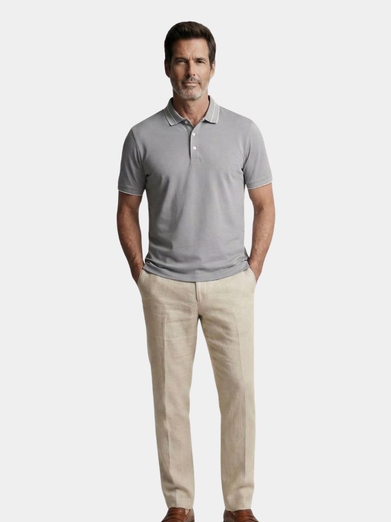 Montaracrest Polo Grigio Acciaio in light gray with classic collar and short sleeves, folded neatly for display.