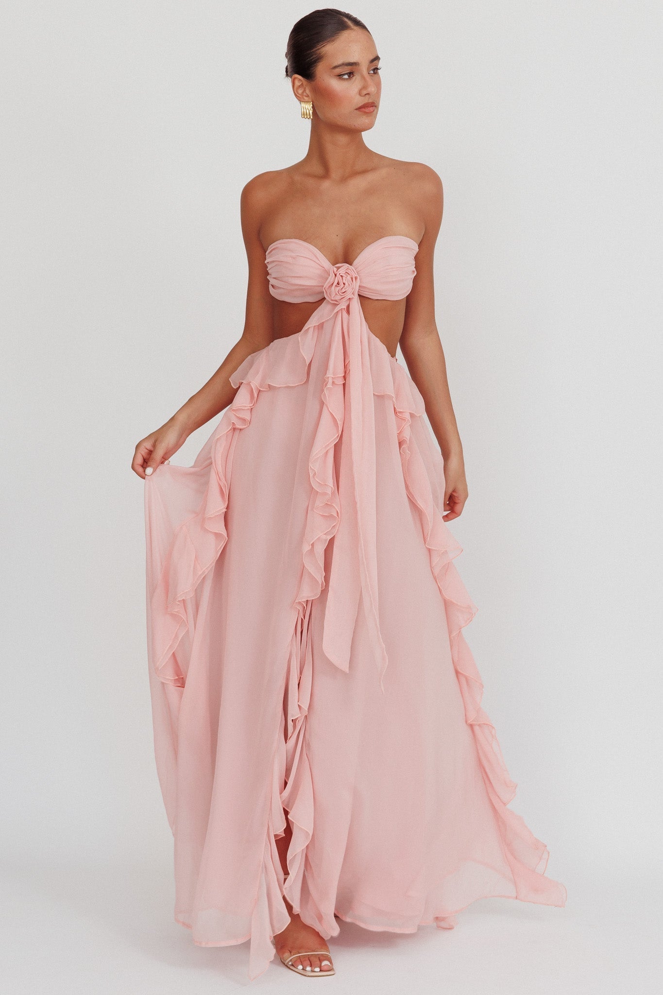 Elegant long strapless dress by Montaracrest with cut-outs and flowing ruffled details, perfect for special occasions.