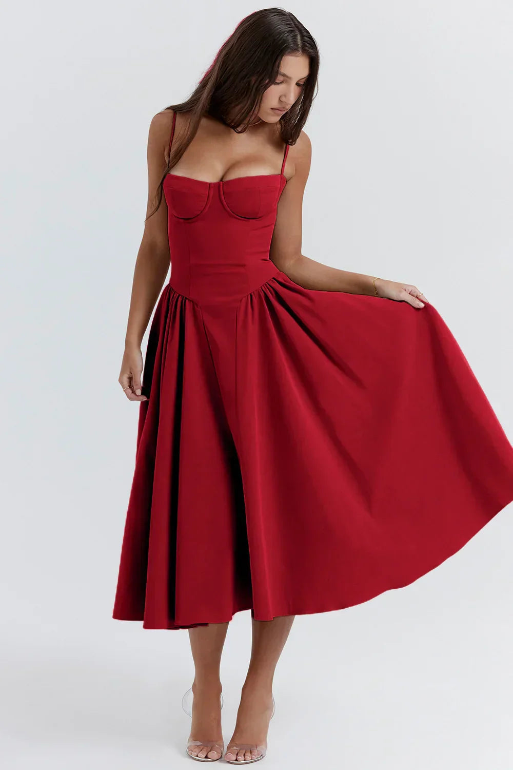Elegant midi pleated dress by Montaracrest with structured bodice and functional pockets, showcasing sophisticated design and craftsmanship.