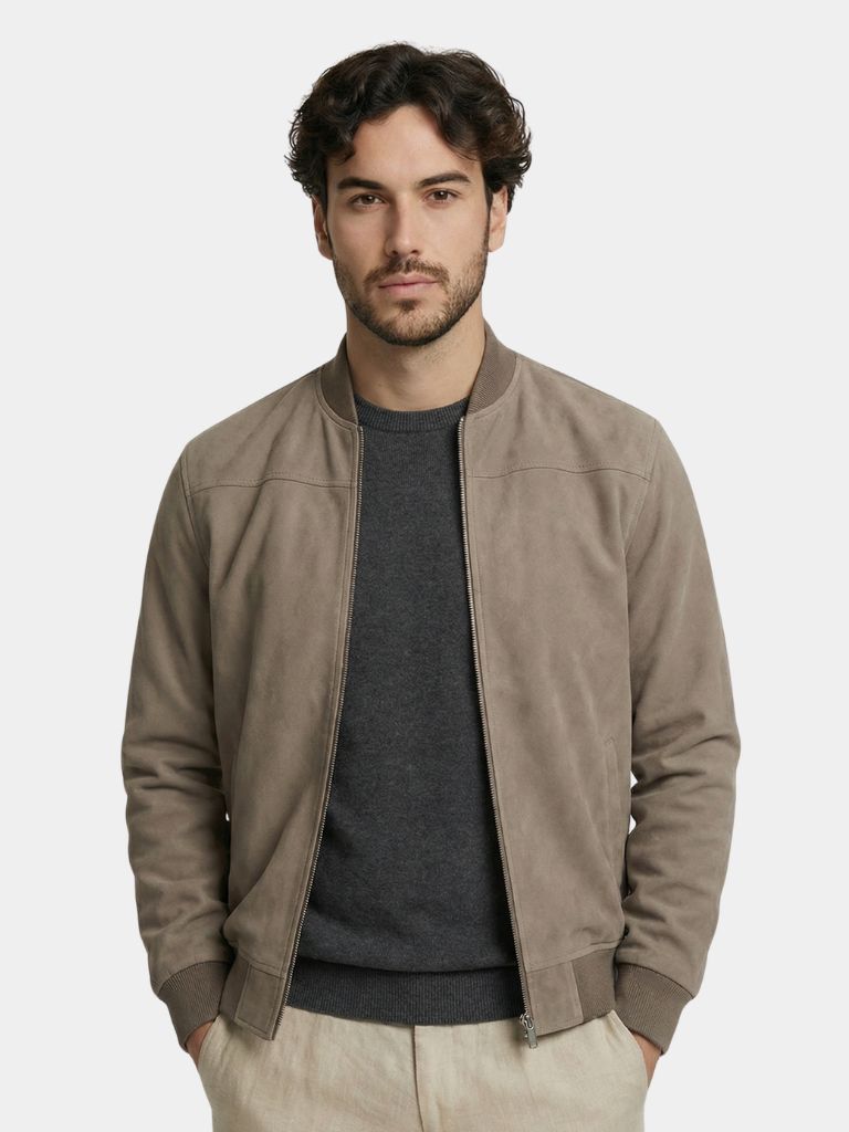 Elegant suede jacket by Montaracrest featuring a tailored fit and classic design, shown hanging on a wooden hanger.