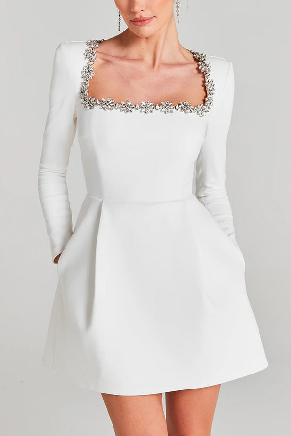 Montaracrest mini A-line dress with jewelry-inspired details, showcasing the elegant fabric and intricate design.