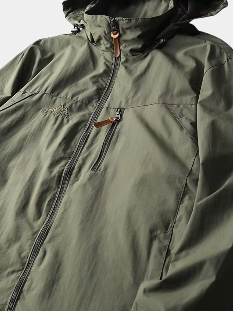 Montaracrest waterproof tactical jacket for expeditions, featuring durable fabric and multiple pockets, shown in a rugged outdoor setting.