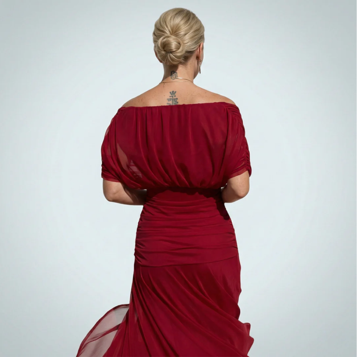 Elegant Montaracrest Luisa long dress with V-neckline and fitted silhouette, displayed with flowing fabric and subtle detailing.