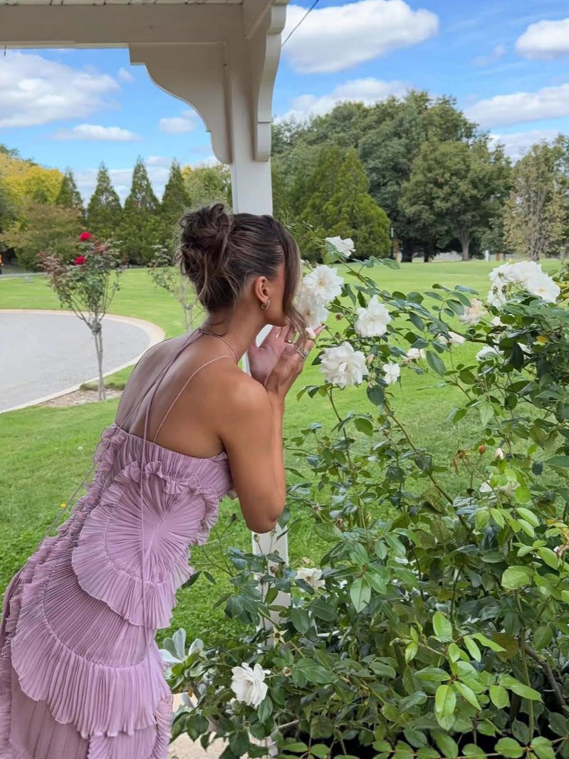 Elegant long pleated dress by Montaracrest with halter neckline and ruffle detailing, showcasing a stylish, flowy design.