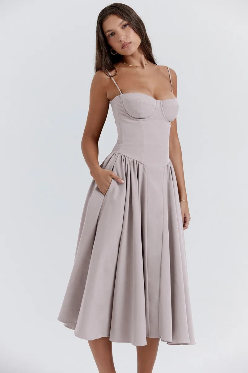 Mid-length pleated dress by Montaracrest featuring structured bodice and side pockets, stylish and elegant for various occasions.
