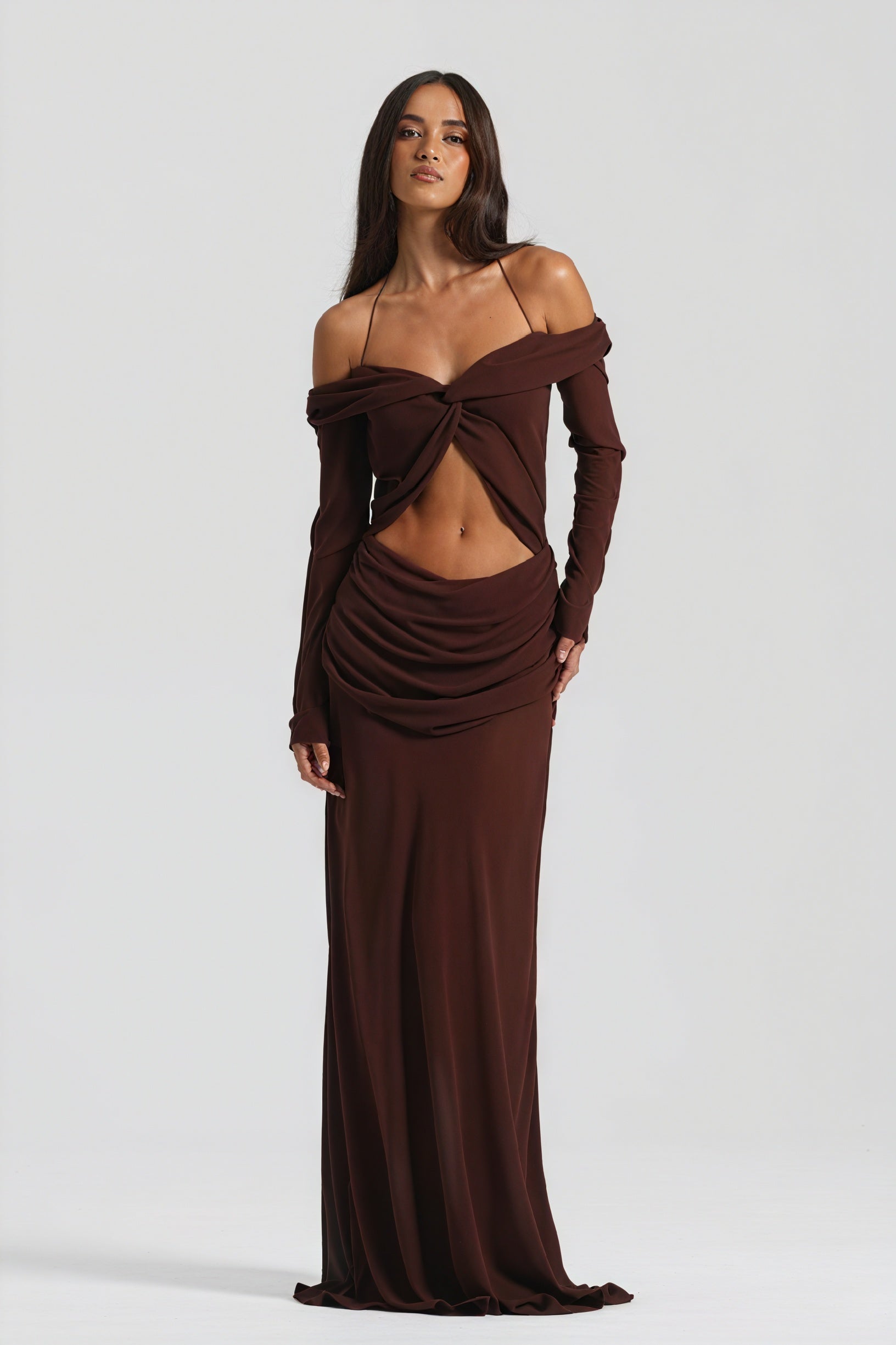 Elegant long dress by Montaracrest with knot detail and cutout design, featuring flowing fabric and sophisticated style.