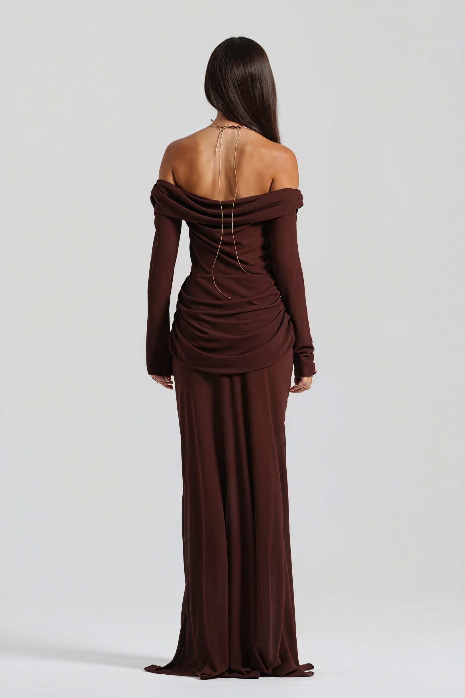 Elegant long dress with knot detail and cutout by Montaracrest, featuring flowing fabric and stylish design.