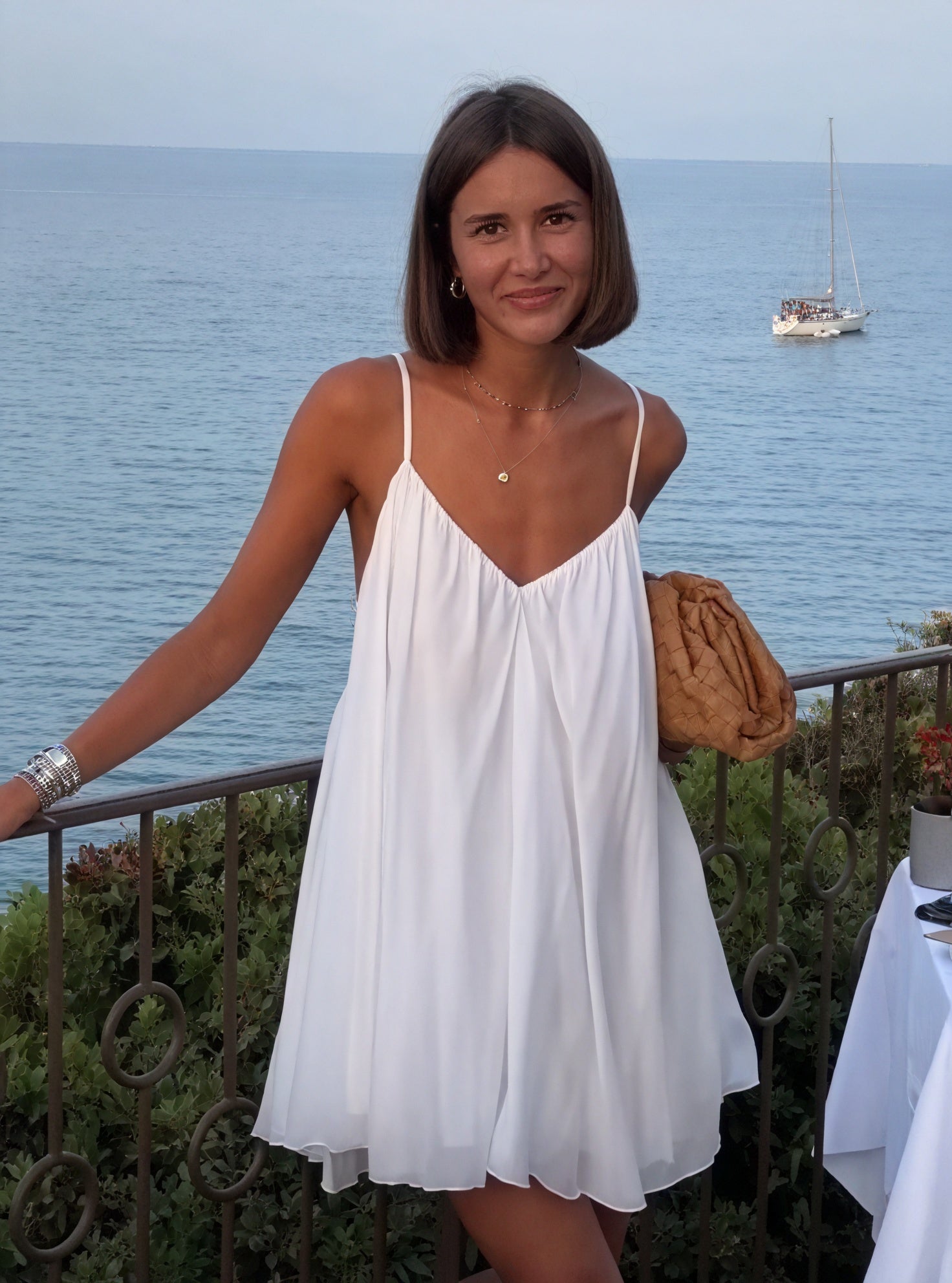 Light and flowy Montaracrest dress with thin straps and V-neckline, featuring elegant drape and soft fabric.
