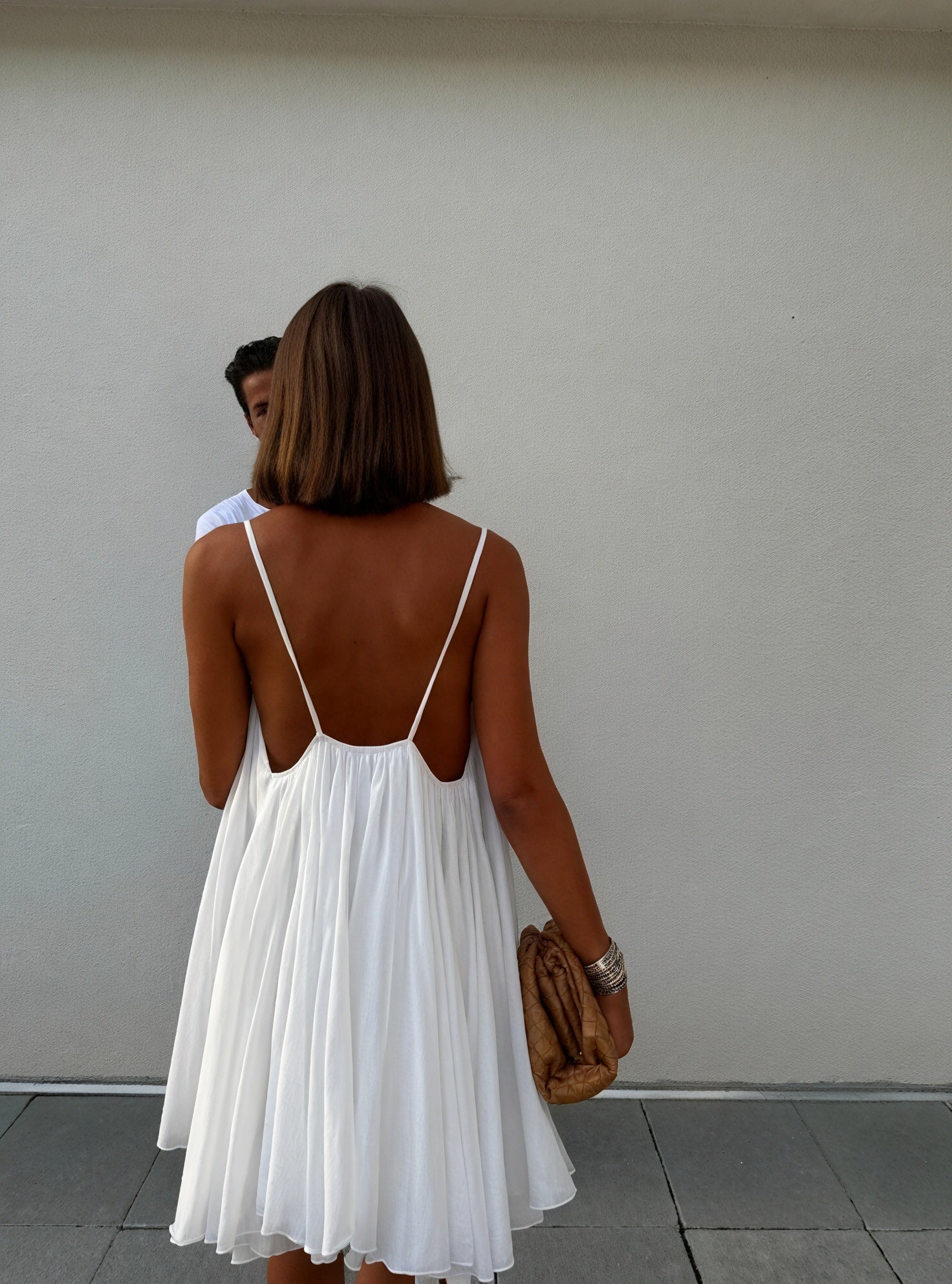 Lightweight flowing dress with thin straps and V-neck from Montaracrest, shown hanging on a hanger.
