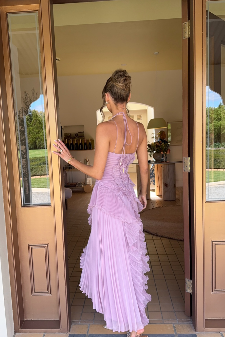 Long pleated halter neckline dress with ruffle details by Montaracrest, featuring a unique flowy silhouette and elegant design.