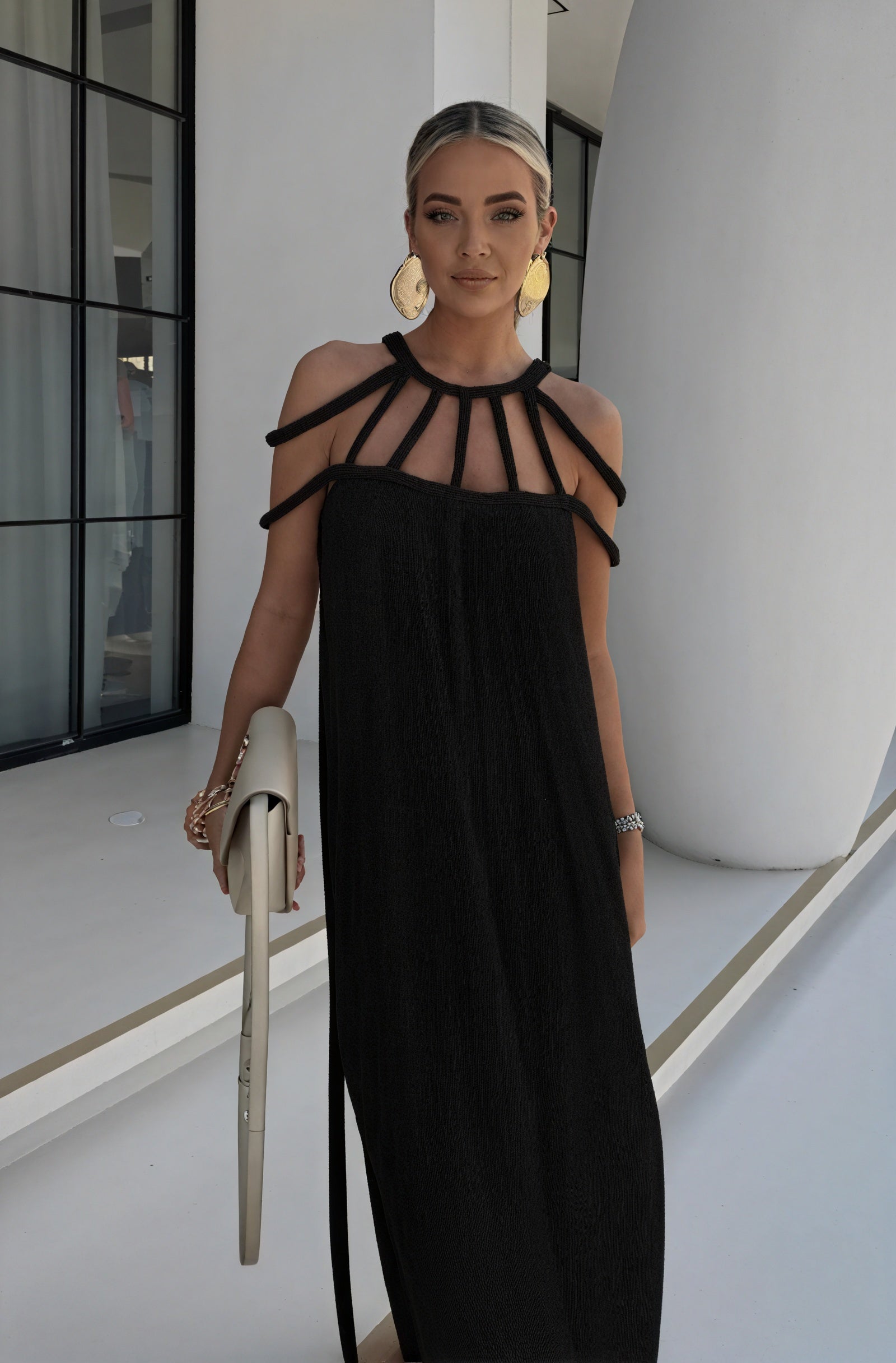 Montaracrest halter dress with braided details and flowing silhouette, showcasing stylish design and intricate fabric textures.