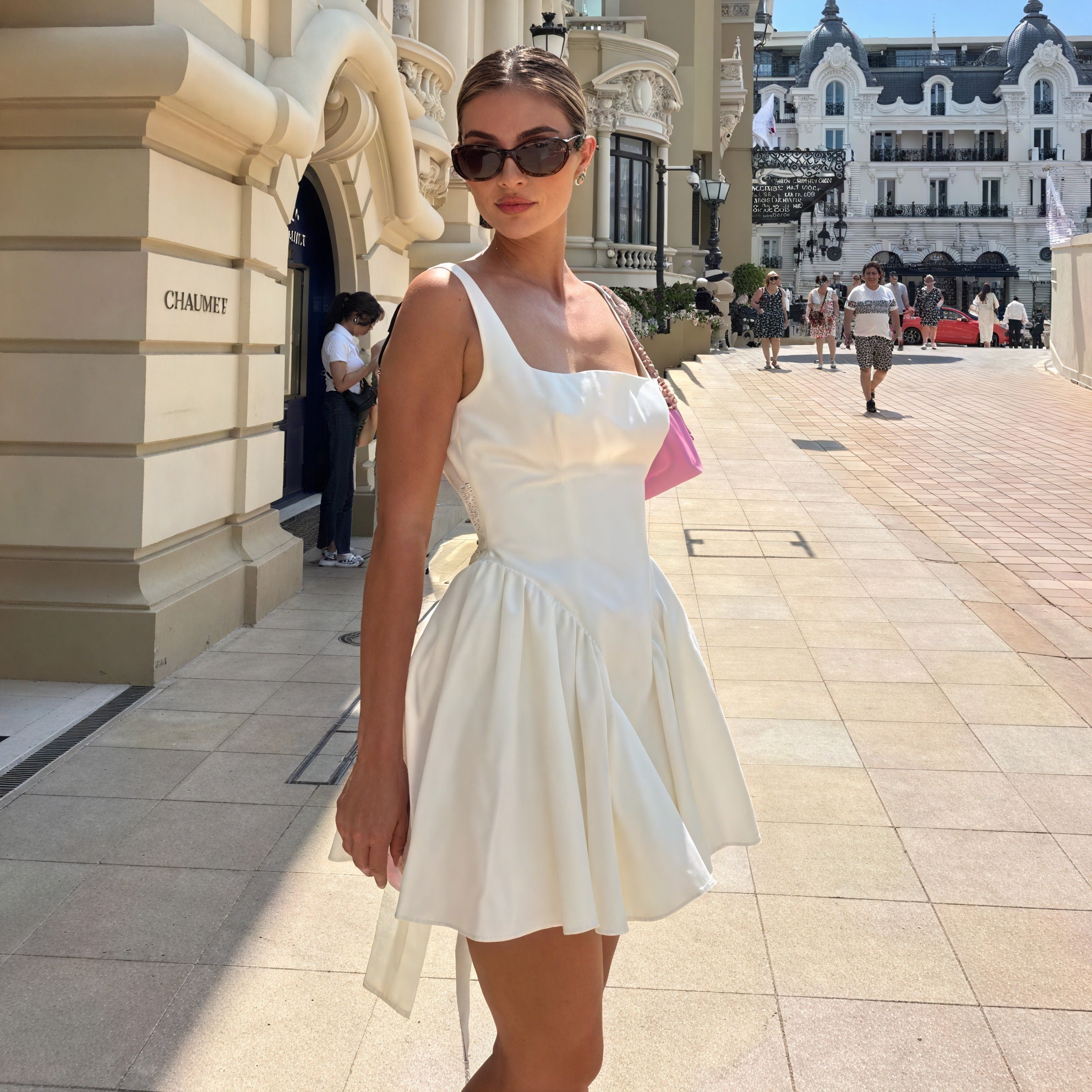 White A-line dress with square neckline and sleeveless design by Montaracrest, shown on a hanger with a simple background.