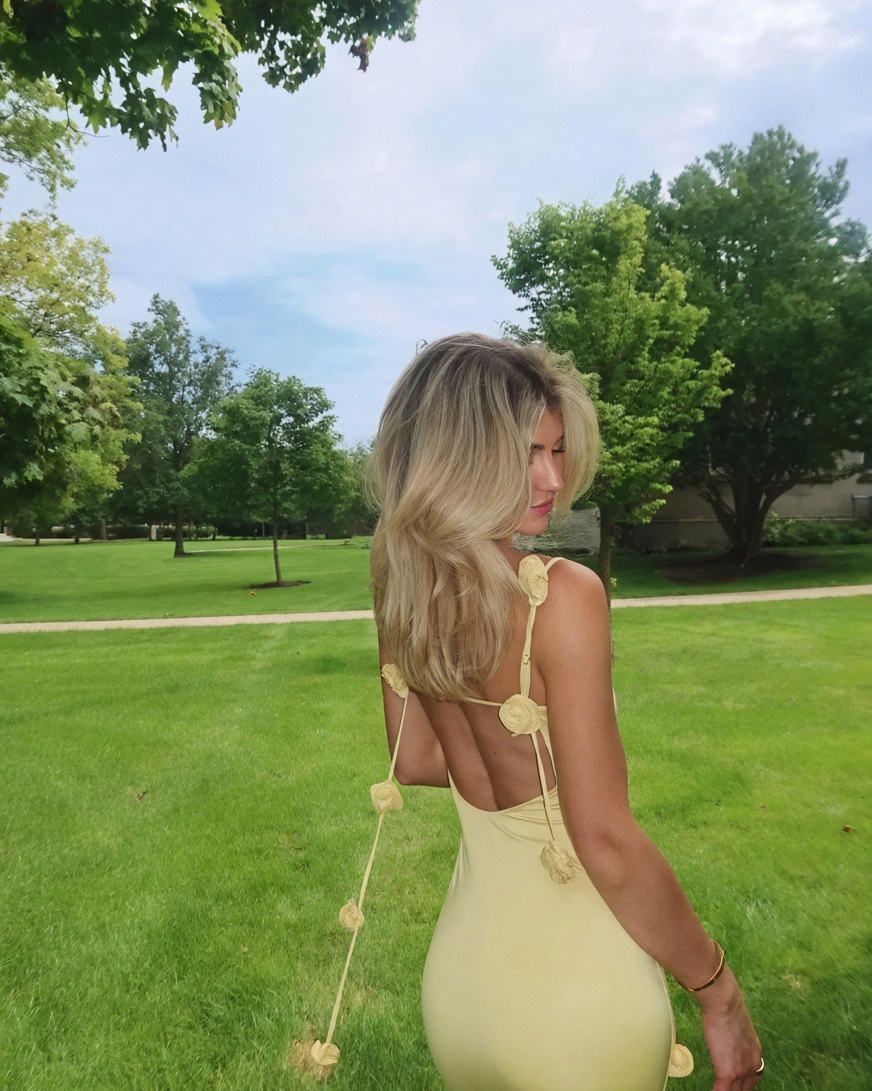Long floral dress for women by Montaracrest featuring an open back and delicate flower details.