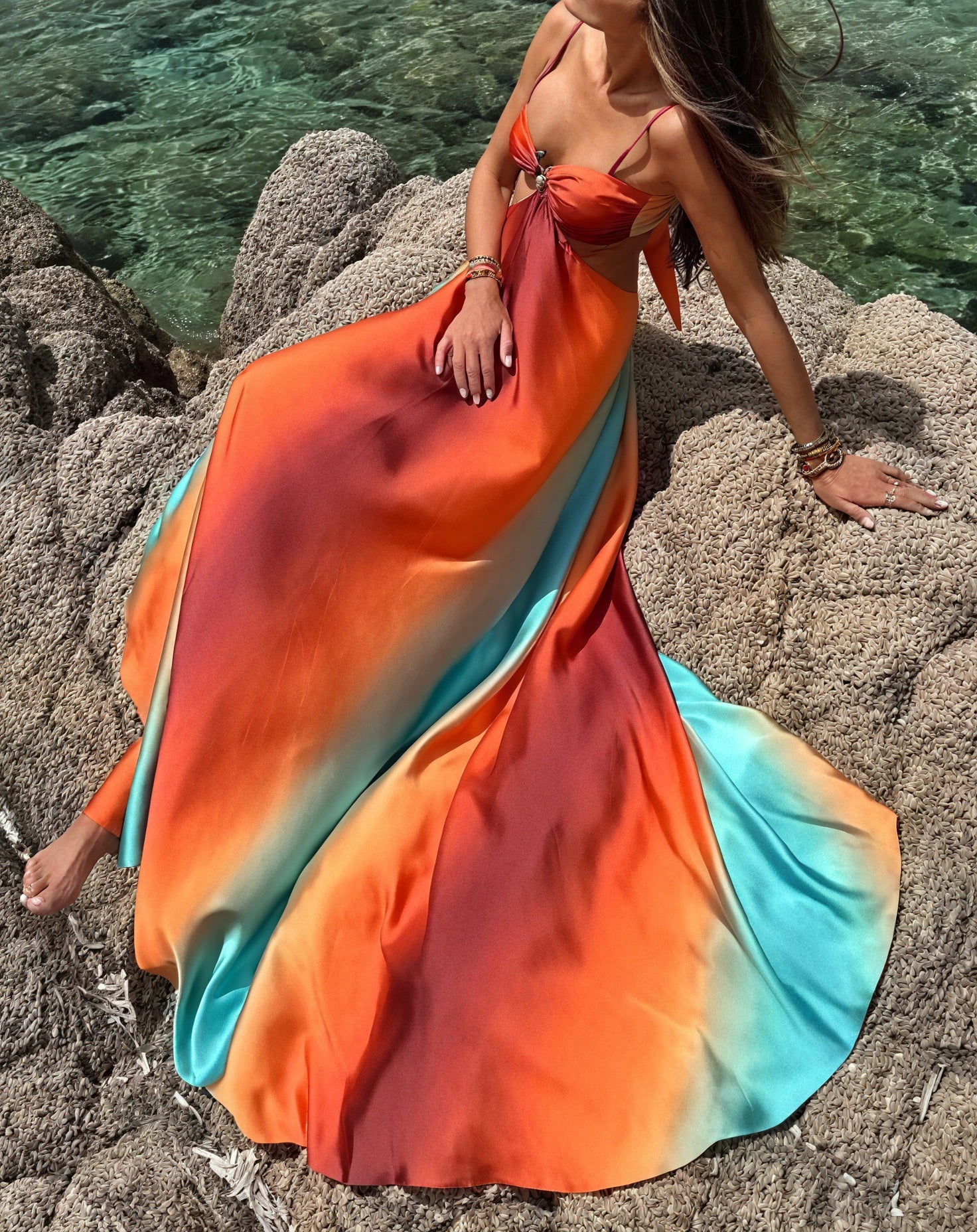 Elegant ombré satin dress with cut-out details by Montaracrest, featuring a sleek, slim-fit silhouette and subtle fabric texture.