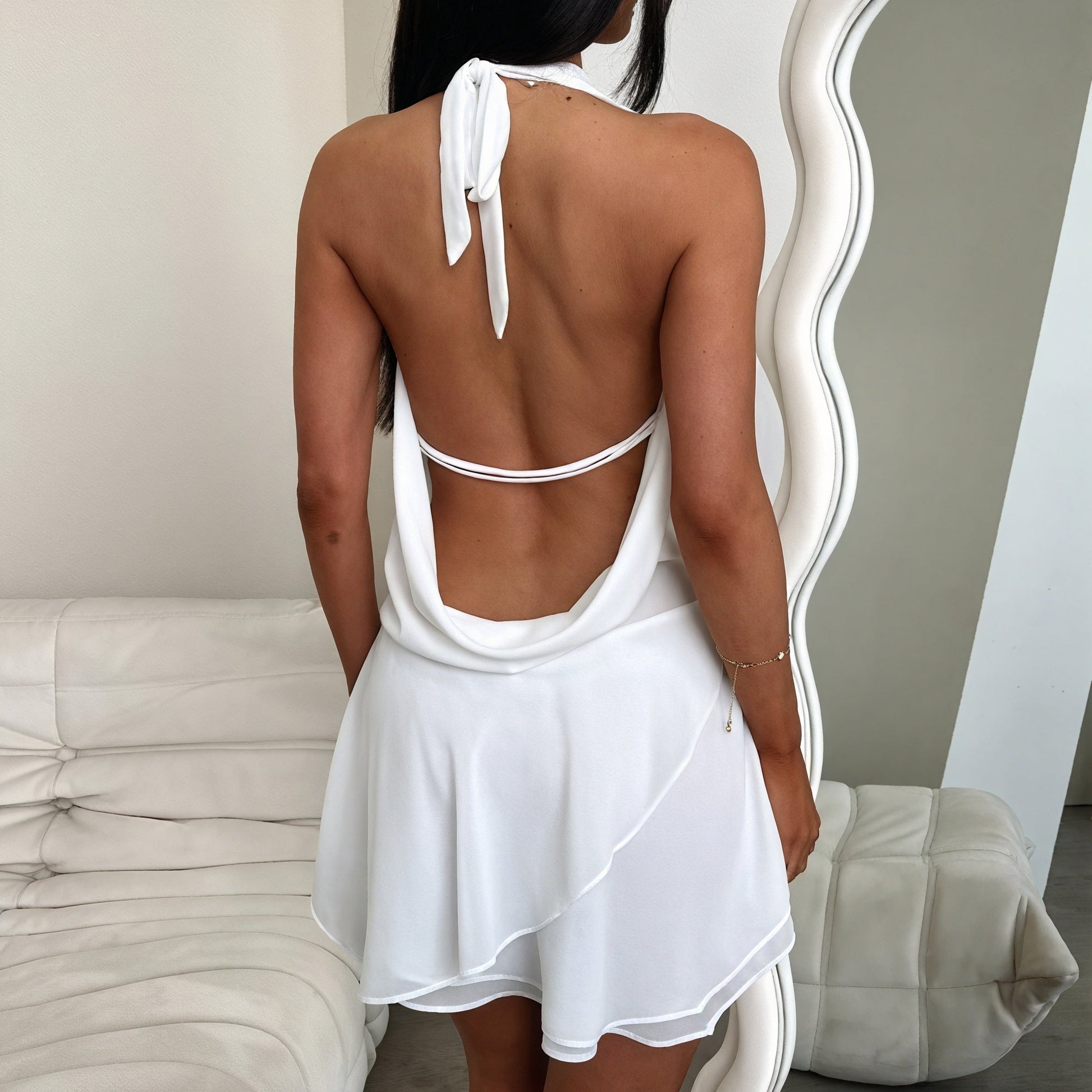 Flowy mini halter dress by Montaracrest featuring a fluid fabric and stylish neckline, perfect for casual or evening wear.