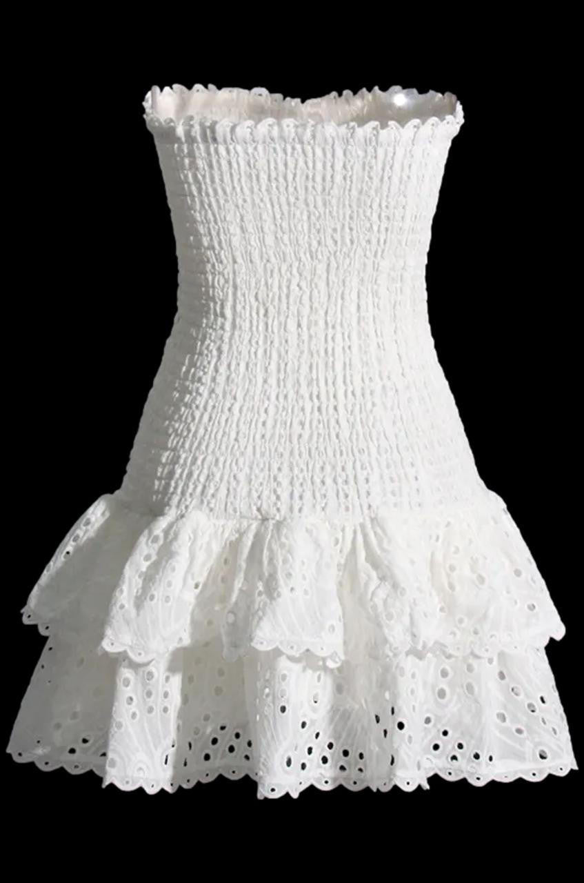 Montaracrest Layorza Broderie Mini Dress in white with anglaise embroidery and strapless design, perfect for summer occasions.