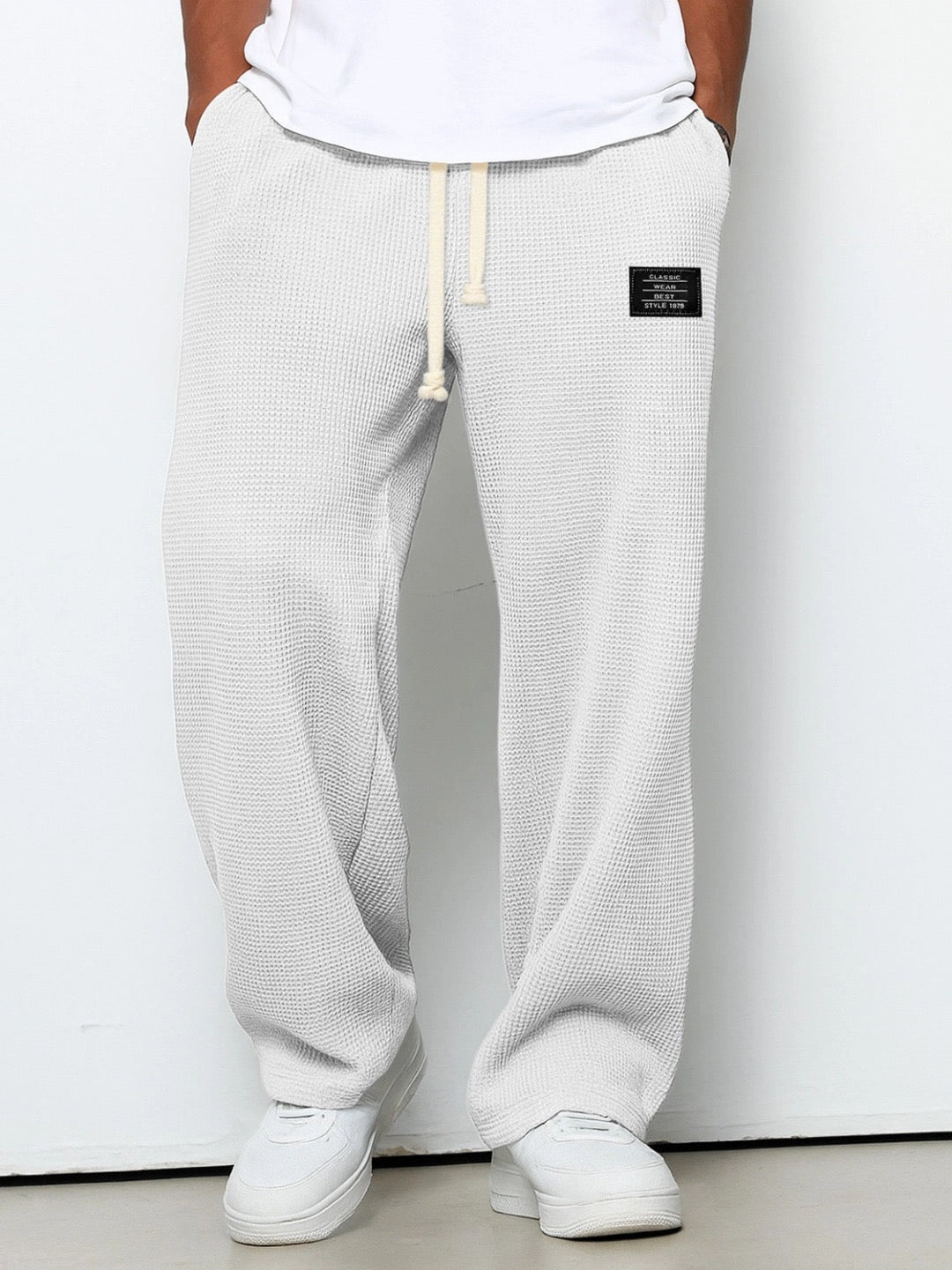 Lorenzo Montaracrest wide-leg pants with honeycomb textured fabric, featuring a relaxed fit and stylish design.