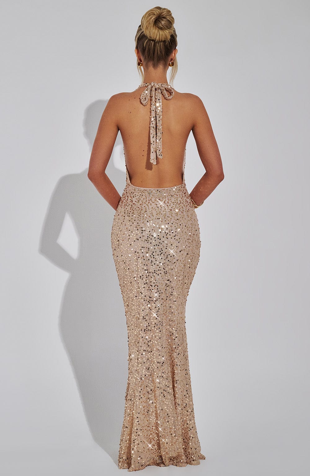 Montaracrest Celeste sequin gown with intricate silver embellishments and flowing fabric, perfect for formal occasions.
