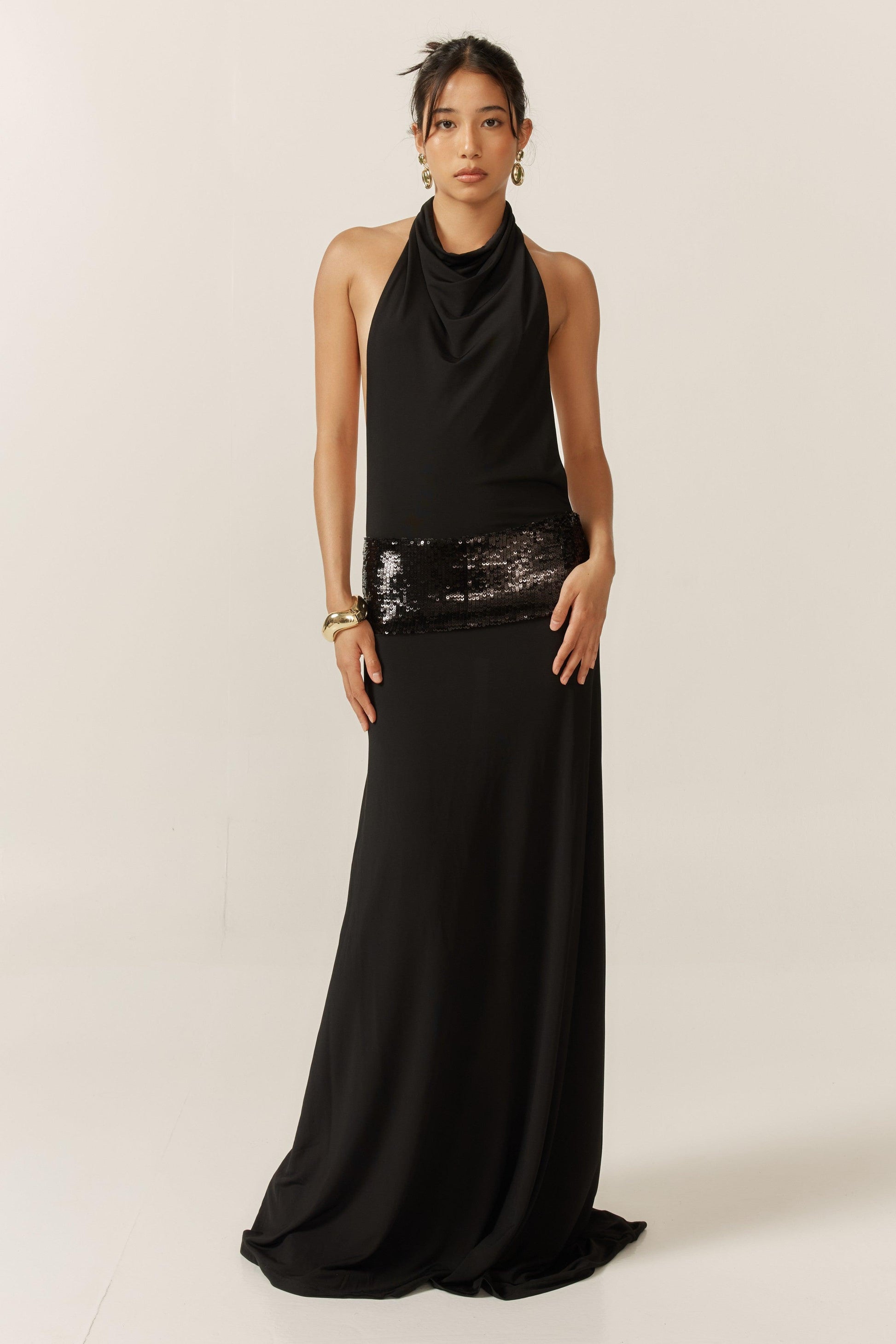 Jade sequin gown by Montaracrest featuring a fitted silhouette and intricate sequin embellishments, displayed on a model.