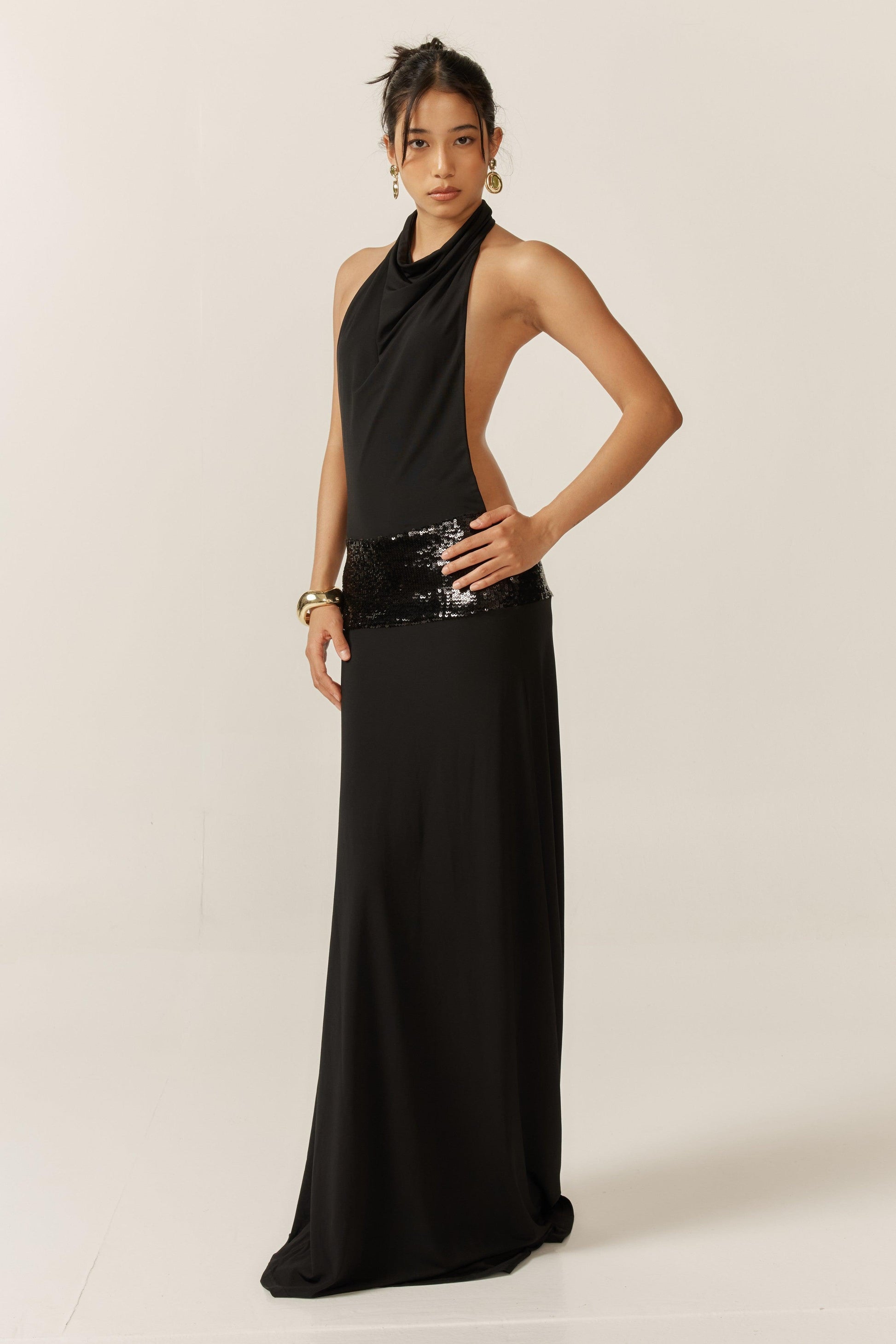 Jade sequin gown by Montaracrest featuring intricate beadwork and a flowing silhouette, shown on a model.