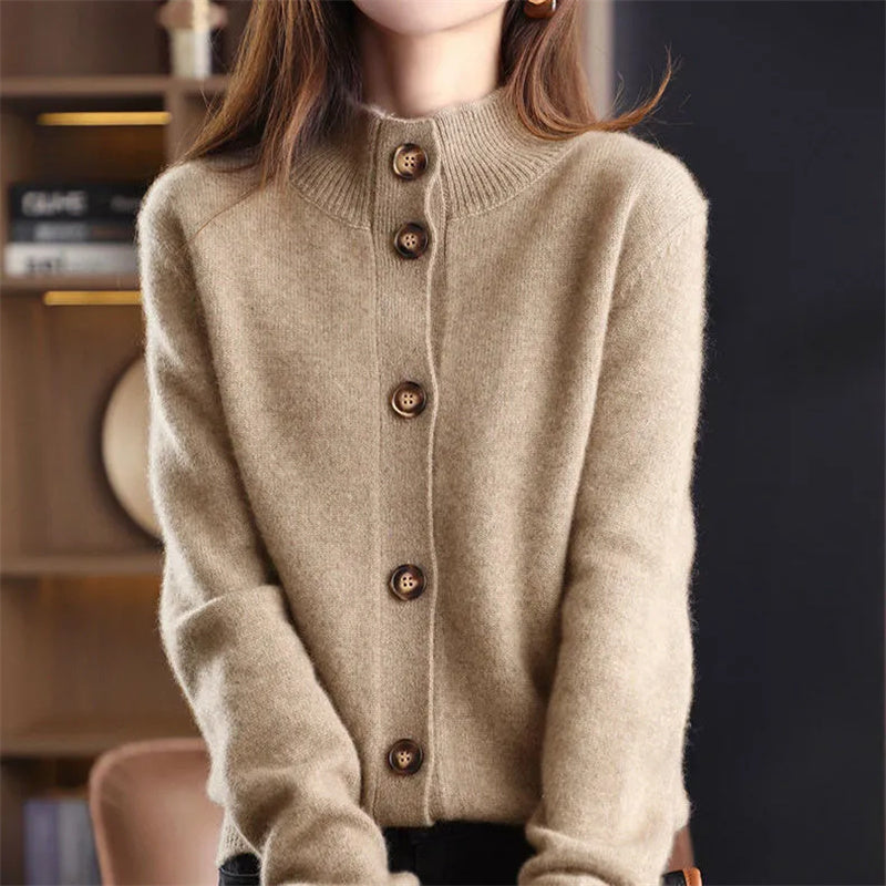 Montaracrest Arlina Merino Cardigan, cream-colored knit sweater with button front and ribbed cuffs, displayed on a hanger.