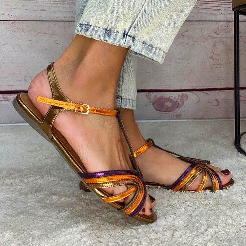Flat sandal with T-strap design from Montaracrest, featuring a comfortable strap and stylish look for casual wear.