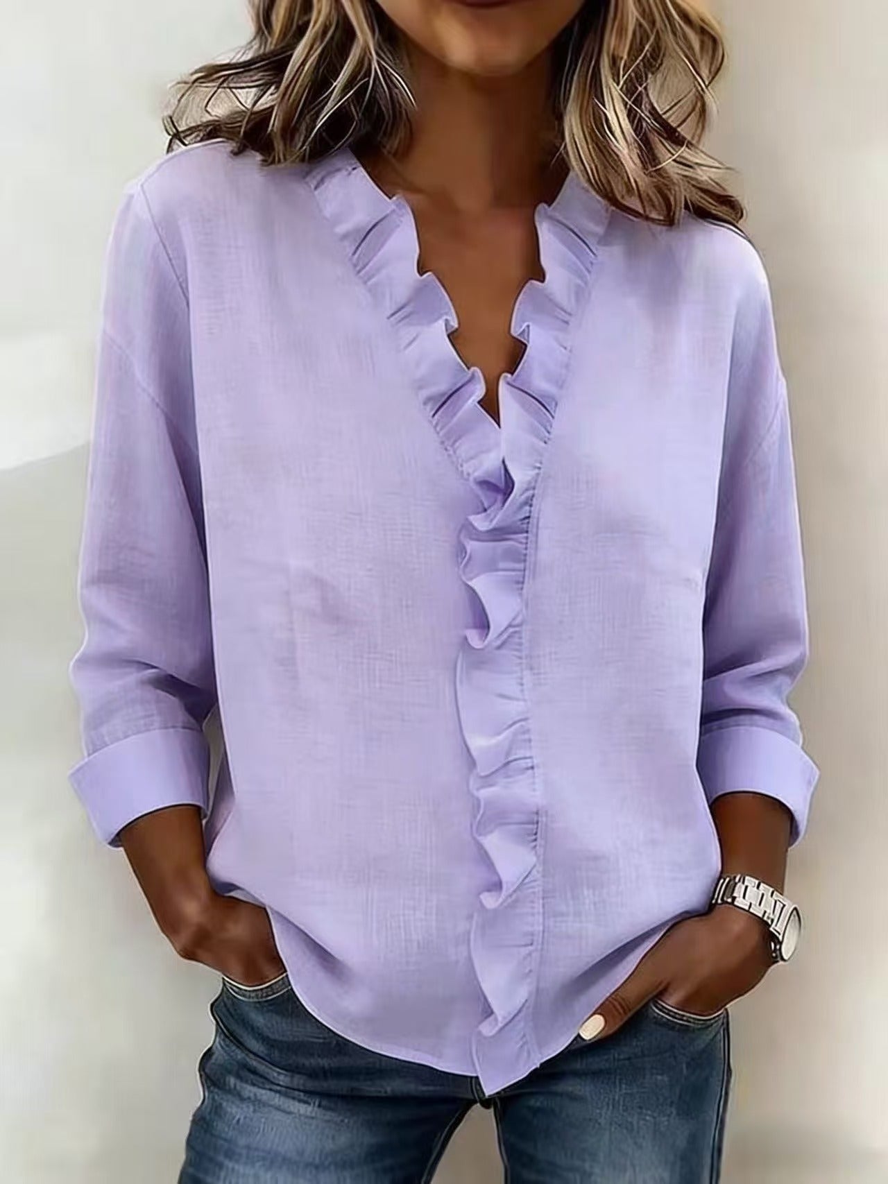 Montaracrest Chiara V-neck blouse with delicate ruffle detail, featuring a stylish and feminine design.