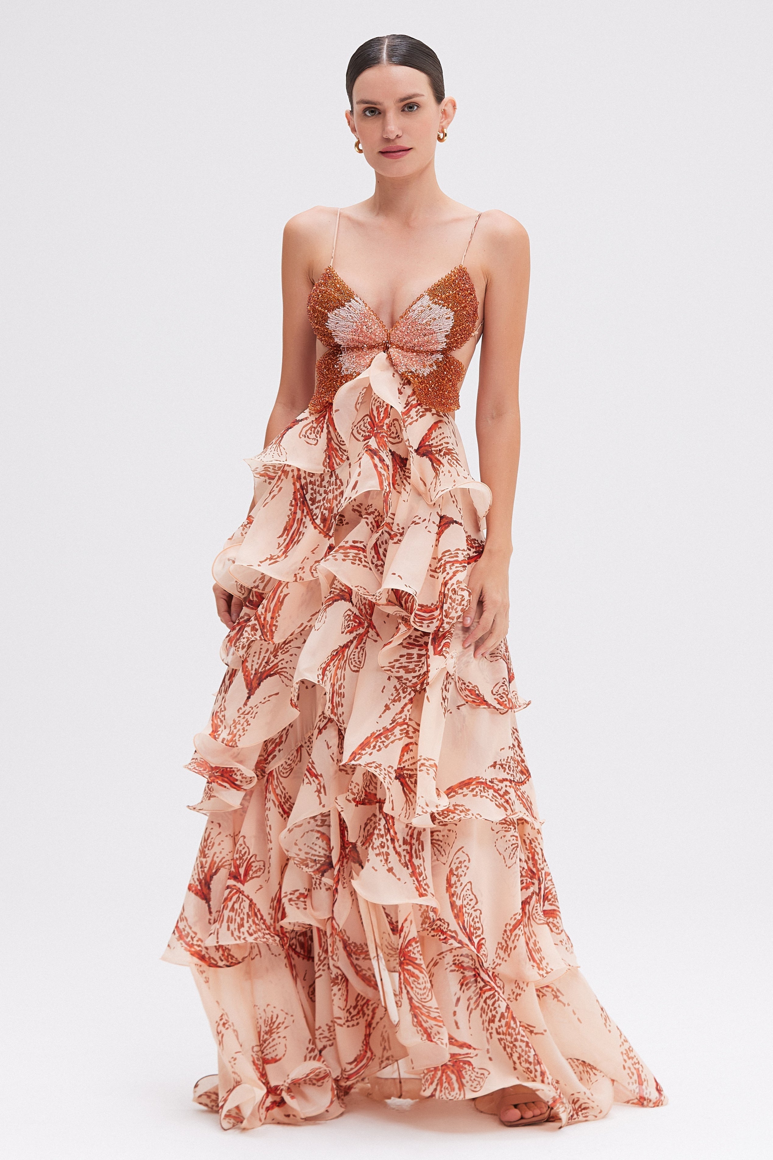 Elegant Amora Ruffle Gown from Montaracrest featuring flowing fabric and ruffled details, perfect for formal occasions.