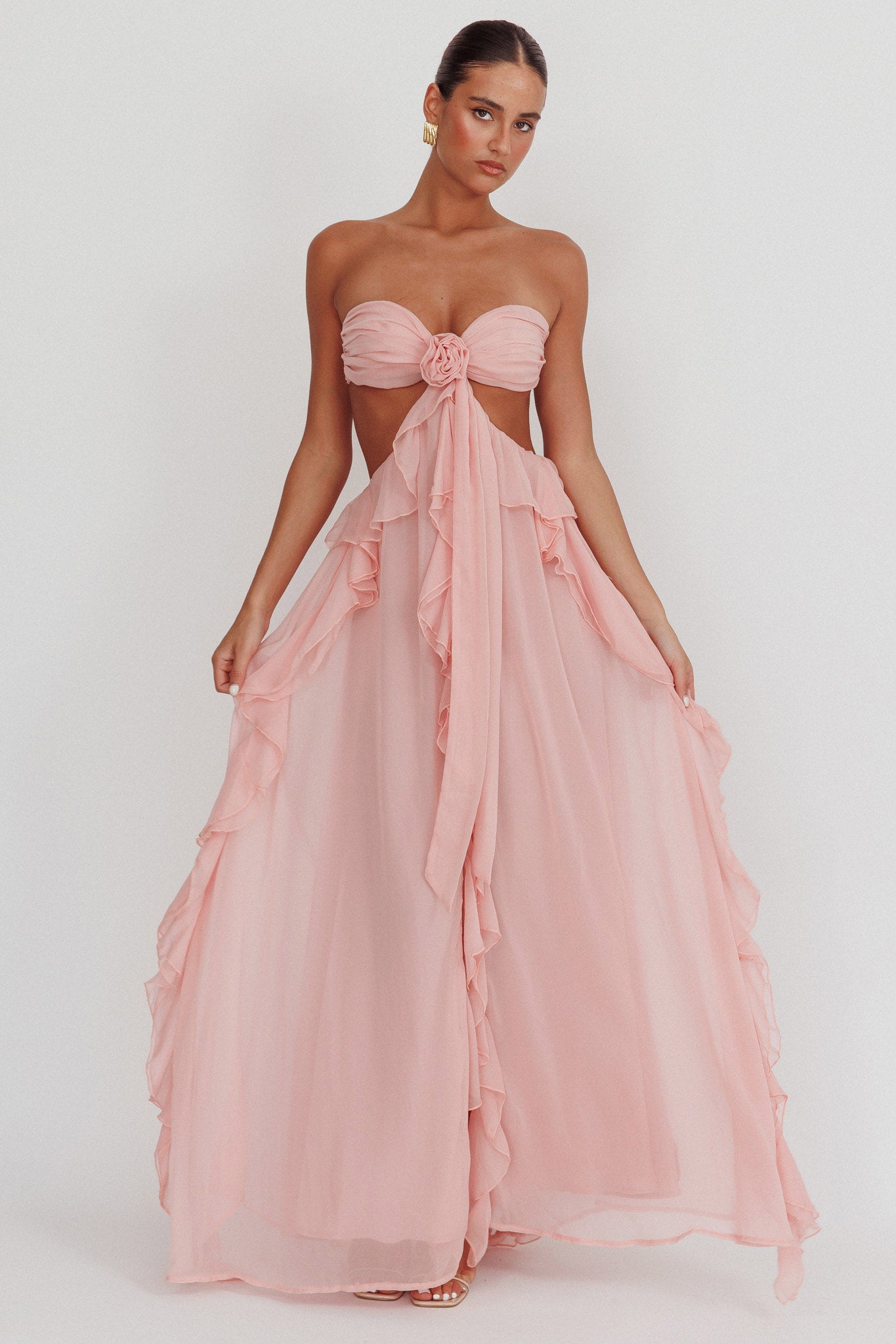 Montaracrest long strapless dress with cut-out details and flowing ruffle accents, perfect for elegant summer occasions.