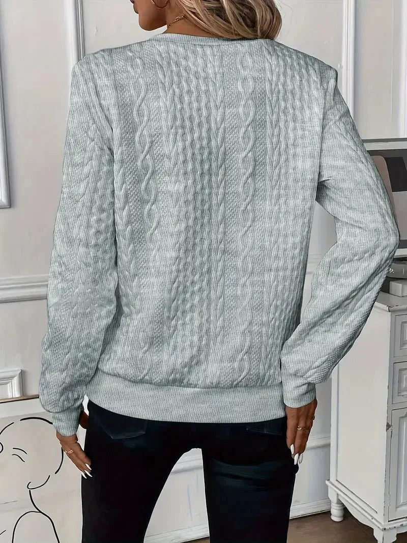 Montaracrest Amy™ sweater with ribbed cuffs and neckline, featuring a cozy knit design in a neutral color.