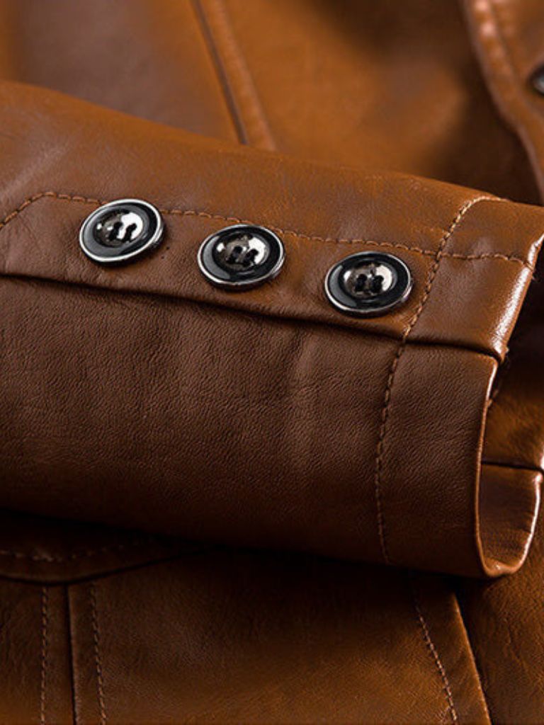 Caramel leather jacket by Montaracrest featuring a bold design and stylish cross crown detail on the front.