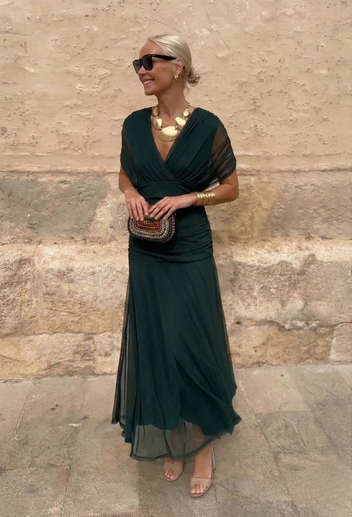 Elegant Montaracrest Luisa long dress with V-neckline that flatters the silhouette, featuring flowing fabric and stylish design.