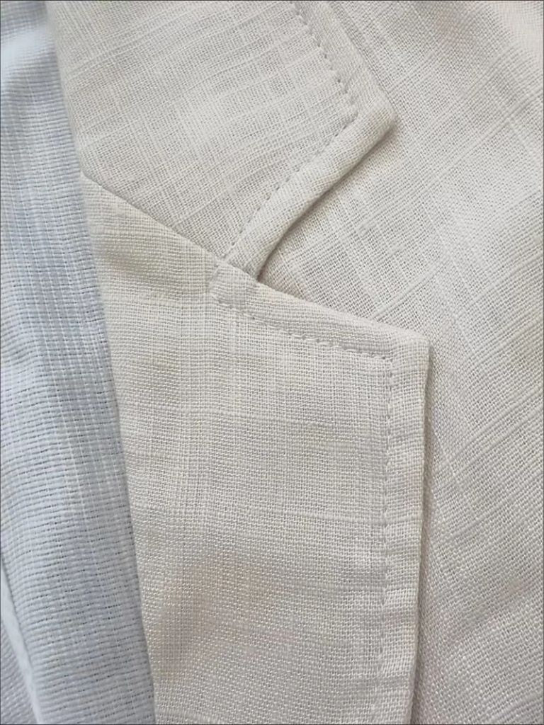 Light beige Gianni summer linen blazer by Montaracrest, featuring a classic fit and cross-crown design, worn casually.