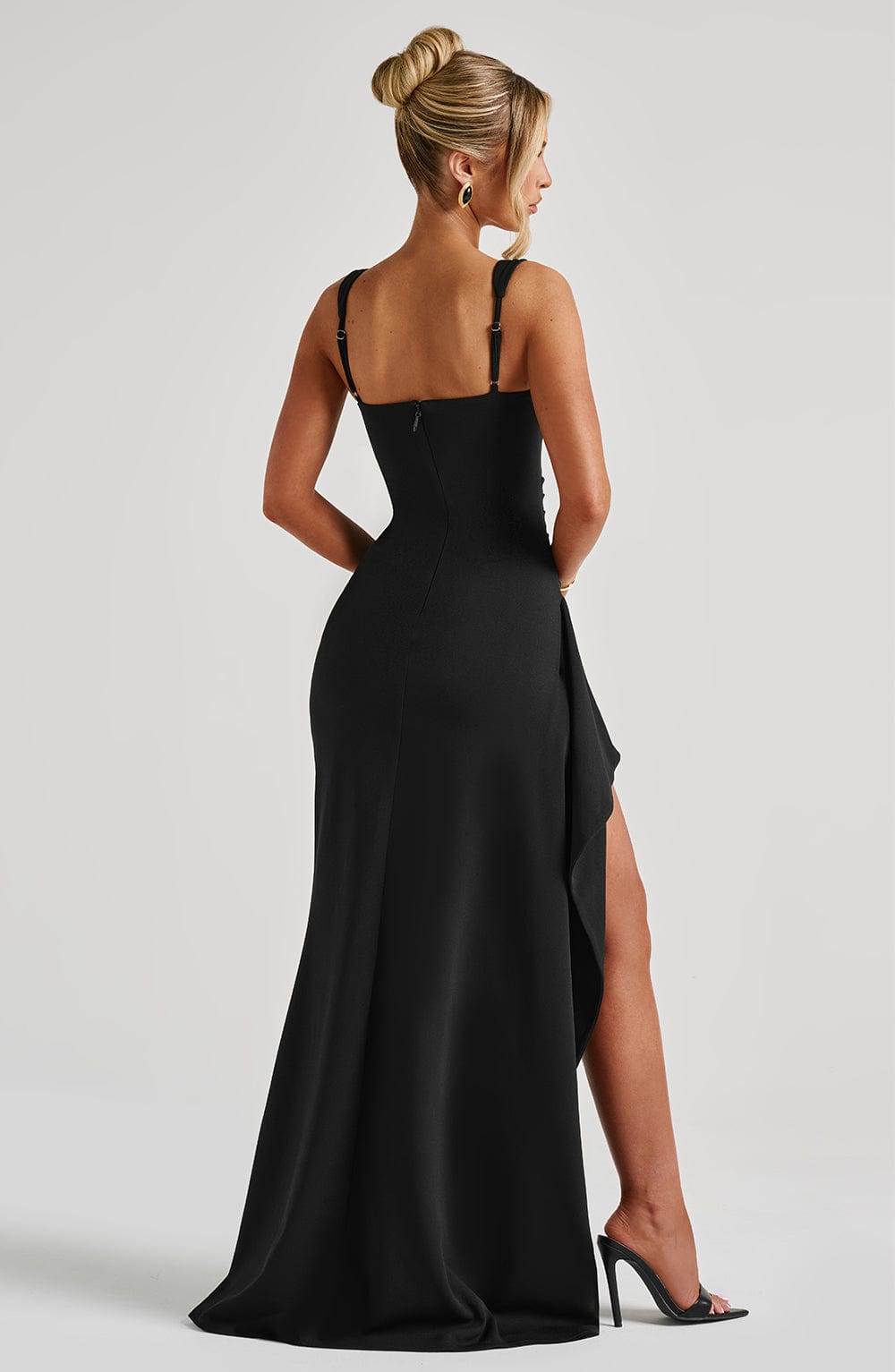 Black Iconic Maxi Dress by Montaracrest featuring a flowing silhouette and elegant design, displayed on a mannequin.
