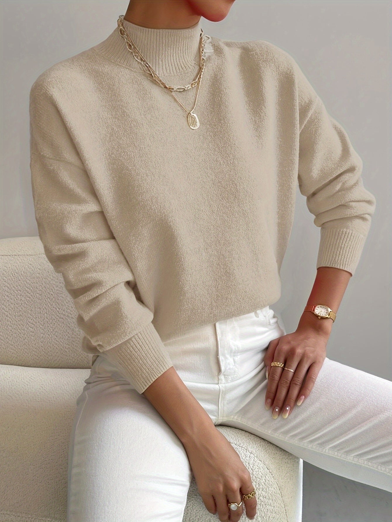 Elegant Montaracrest Seraphine high-neck wool sweater worn by a woman, stylish and comfortable for cold weather.