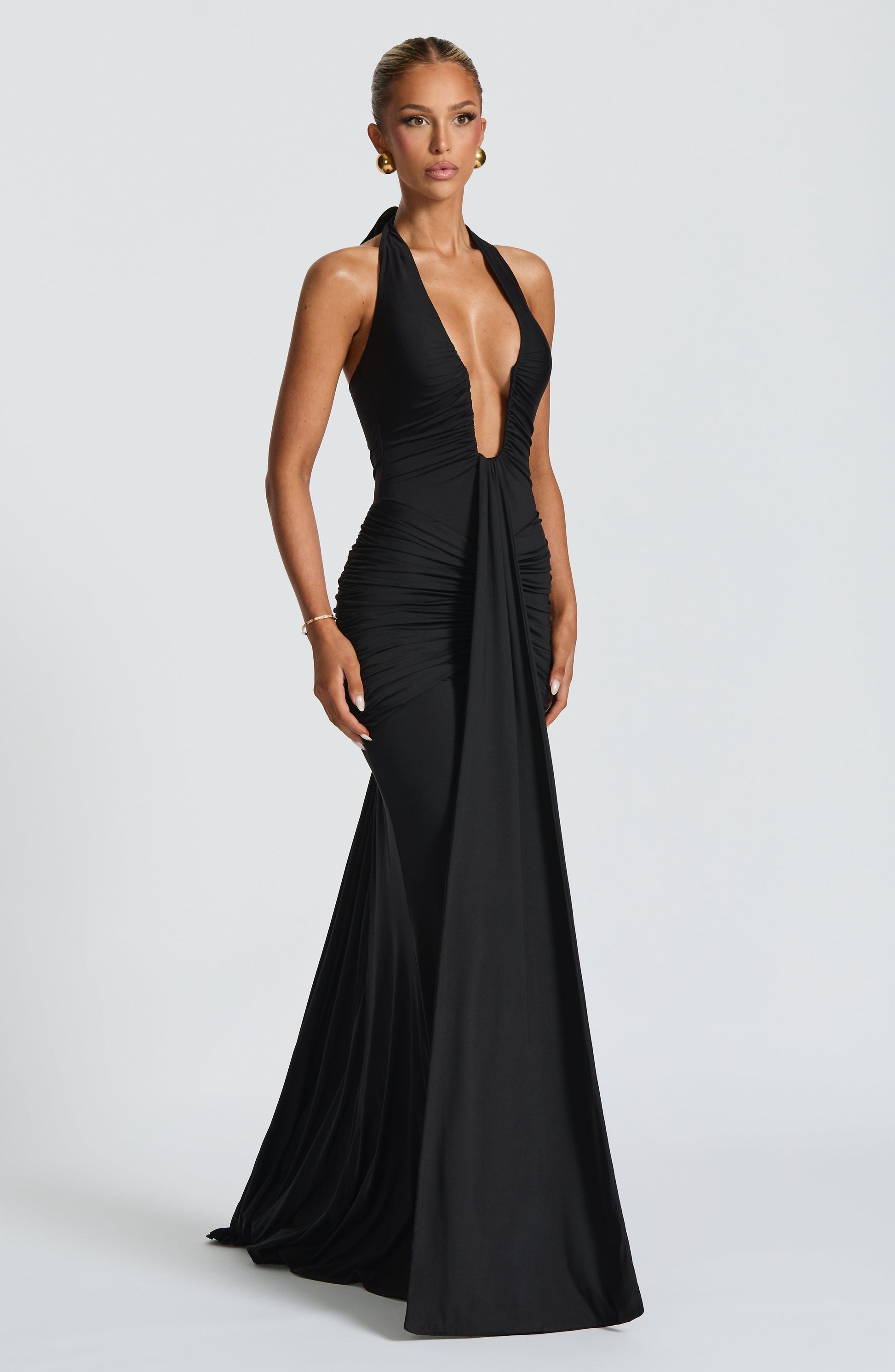 Black Freja Halterneck Dress by Montaracrest featuring a flowing maxi design and elegant halterneck style.